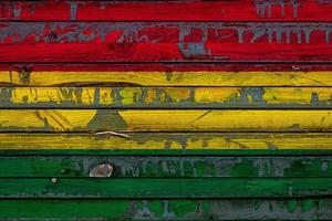 The national flag of Bolivia is painted on uneven boards. Country symbol. photo