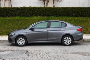 Side Turkey  March 03 2022      gray Fiat Egea   is parking  on the street on a  summer day Side Turkey  March 03 2022      gray Fiat Egea   is parking  on the street on a  summer day photo