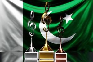 Treble clef awards for winning the music award against the background of the national flag of  Pakistan, 3d illustration. photo