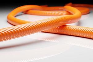3d illustration orange hollow plastic hose isolated on white background photo
