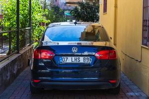 Side Turkey  February 20 2022 blue   Volkswagen Jetta is parked  on the street on a warm summer day against the backdrop of a buildung, trees photo