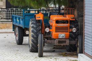 Side  Turkey  February  20, 2022  Old orange Tractor of brand Turk Fiat 640  is parked  on the street on a warm  day photo