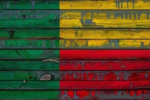 The national flag of Benin is painted on uneven boards. Country symbol. photo