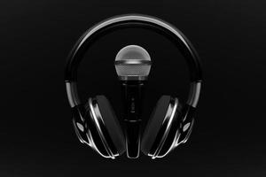 microphone, round shape model and wireless headphones on black background, realistic 3d illustration. photo