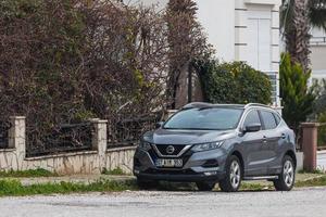 Side Turkey  February 20 2022    silver  Nissan Qashqai  is parked  on the street on a warm day photo