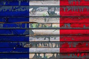 The national flag of France is painted on uneven boards. Country symbol. photo