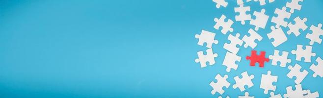 Top view of jigsaw puzzle on blue background photo