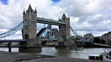 A view of Tower Bridge in London with drawbridge opening photo