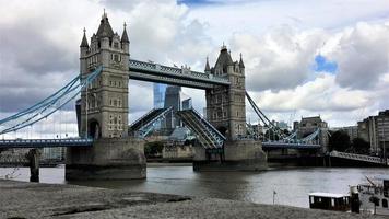 A view of Tower Bridge in London with drawbridge opening photo