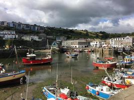 Mevigissy in Cornwall in the UK in August 2020. A view of Mevigissy Harbour showing all the fishing boats photo