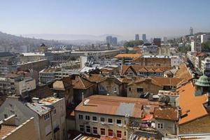 Sarajevo, Bosnia and Herzegovina - June 5, 2022 - Beautiful view over the city of Sarajevo with hills in the background on a sunny day. photo