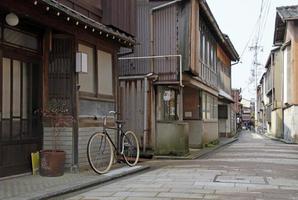 14 June 2022 - Kanazawa, Japan - Bicycle in a quiet street in the old town of Kanazawa, Japan photo