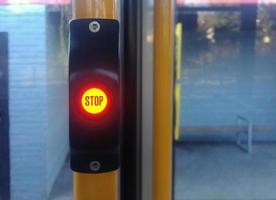 Bright STOP button on a tram