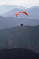 Paraglider in front of a mountain range panorama in the alps photo