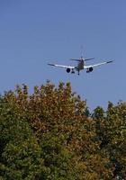 Aircraft noise - low-flying air plane during its approach photo