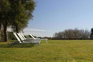 Inviting seats and sun beds in a park near Nice, France photo