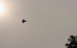 Fighter jet flying past the sun in Japan photo