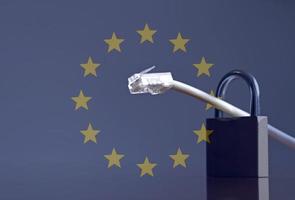 Network cable going through a padlock and the European Union flag photo