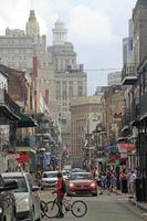 12 April 2018 - New Orleans, Louisiana, United States - Street scene in the French Quarter of New Orleans, Louisiana, with the higher downtown buildings in the background. photo