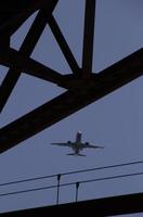 Aircraft noise - low-flying air plane during its approach photo