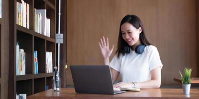 Asian girl student online learning class study online video call zoom teacher, Happy asian girl learn english language online with computer laptop. photo