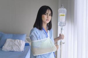 Hopeful and happy young patient woman in hospital, healthcare and medical concept photo