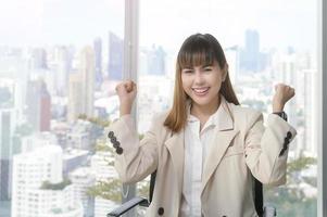 Portrait of young beautiful Business Woman smiling in modern office photo