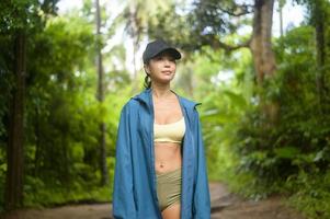 Beautiful asian woman in sportswear trekking on mountain trail, Travel and ecotourism concept. photo