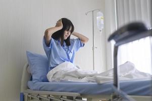 A despondent Asian woman patient. Following the doctor's declaration that the cancer was nearing the end of its course. photo