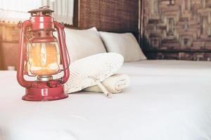 Old lantern on white bed in native local resort without electricity in Thailand - conservation local travel resort concept