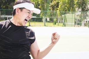Tennis player aggressively expresses his victory photo
