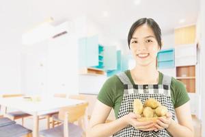 Happy lady holding kichen stuff over copy space background - people home made food preparation concept photo