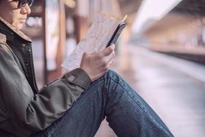 Travel man wait train at platform - people vacation lifestyle activities at train station transportation concept photo