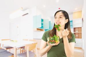 Happy lady holding kichen stuff over copy space background - people home made food preparation concept photo