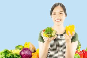 Happy lady holding kichen stuff over copy space background - people home made food preparation concept photo