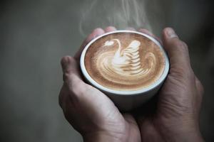 Hand holding hot coffee cup - people with coffee background concept photo