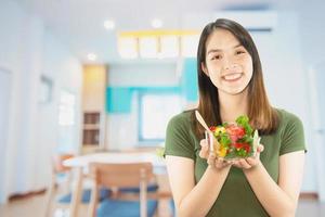 Happy lady holding kichen stuff over copy space background - people home made food preparation concept photo