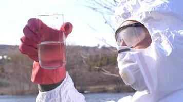 Water analysis, polluted lake analysis. The expert examines the water sample taken from the lake. Water testing and analysis. video