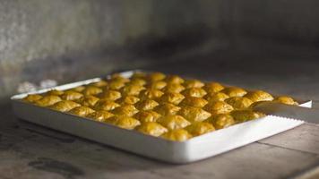 The chef taking the dessert from the oven.  The cook takes the fried baklava from the oven. Turkish baklava dessert. video
