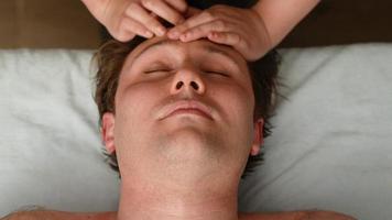 Massage for headache and neck pain. Man getting head massage for pain relief. video