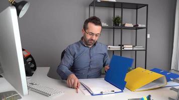 Stressed and nervous office worker. stressed and nervous office worker working on paperwork. video