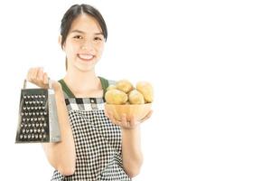 Happy lady holding kichen stuff over copy space background - people home made food preparation concept photo