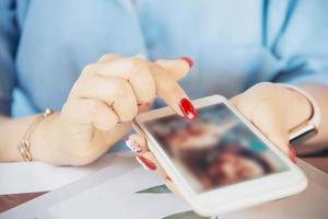 mujer usando teléfono móvil - mano de cerca con el concepto de tecnología móvil foto