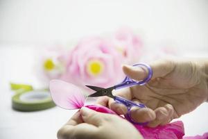 mujer haciendo una hermosa flor de nailon - gente con concepto de flor hecha a mano diy foto