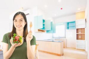 Happy lady holding kichen stuff over copy space background - people home made food preparation concept photo