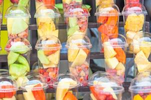 Fresh mix fruit in glasses prepare for blended menu - colorful fresh fruit background concept photo