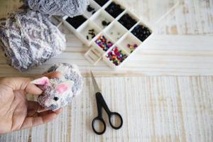 Woman making lovely bunny doll from yarn  - Easter holiday celebration concept photo