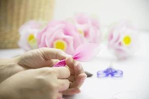 Woman making beautiful nylon flower - people with DIY handmade flower concept photo