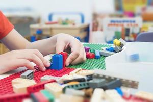 Boy play colorful toy block puzzle set for brain practice photo