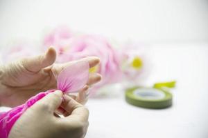 Woman making beautiful nylon flower - people with DIY handmade flower concept photo